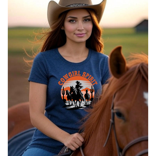 Woman wearing a 'Cowgirl Spirit' t-shirt with a horse and cactus design, standing next to a horse in a field.