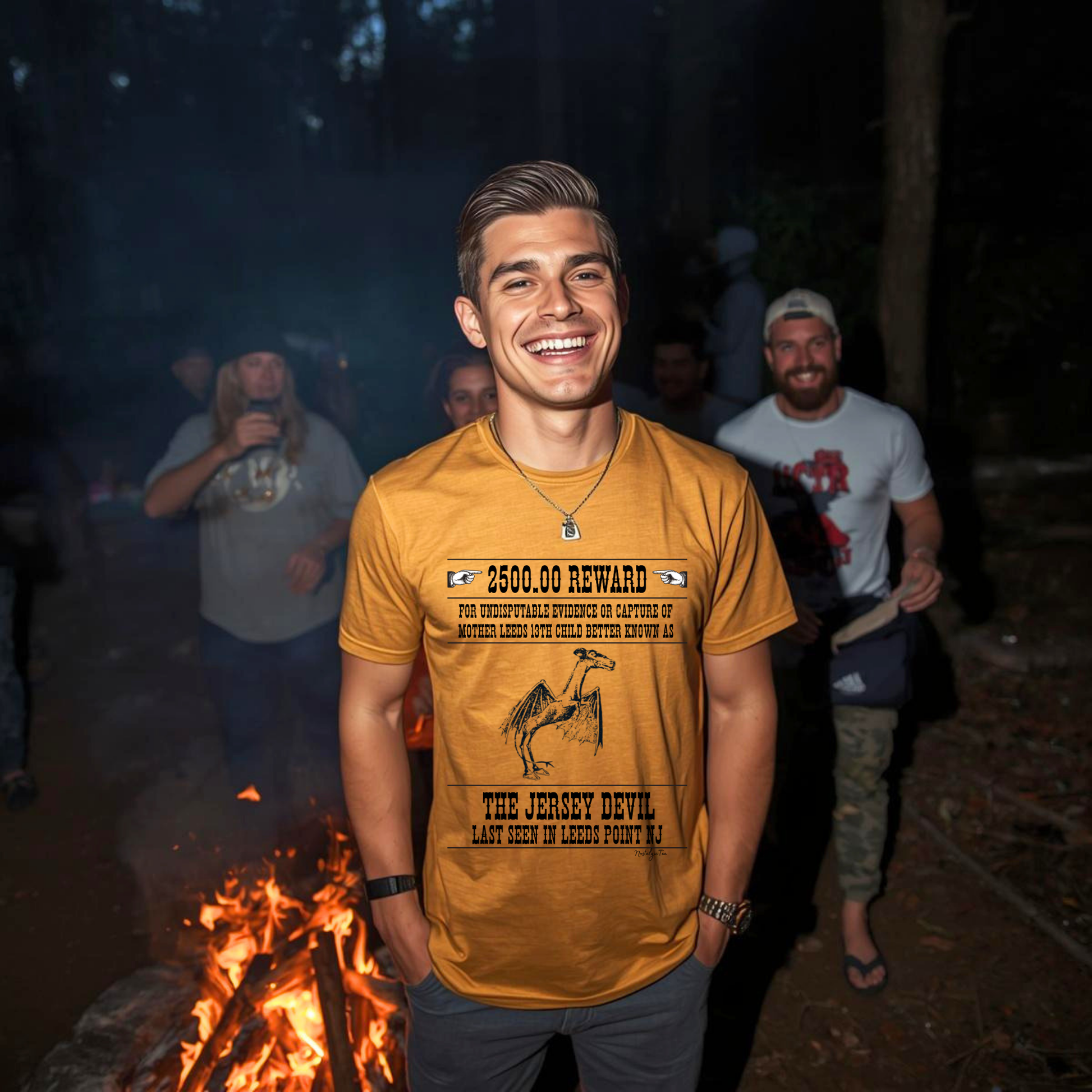 man at a campfire laughing with friends wearing jersey devil graphic tee