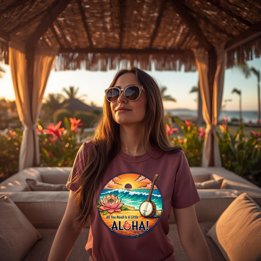 Woman wearing a t-shirt with a tropical design and 'Aloha' text, standing in a thatched-roof gazebo with flowers and ocean view.